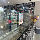 Inside Rosa Ice Cream with the flavor menu boards