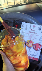 Mango ice cream cup with a Rosa Ice Cream menu card