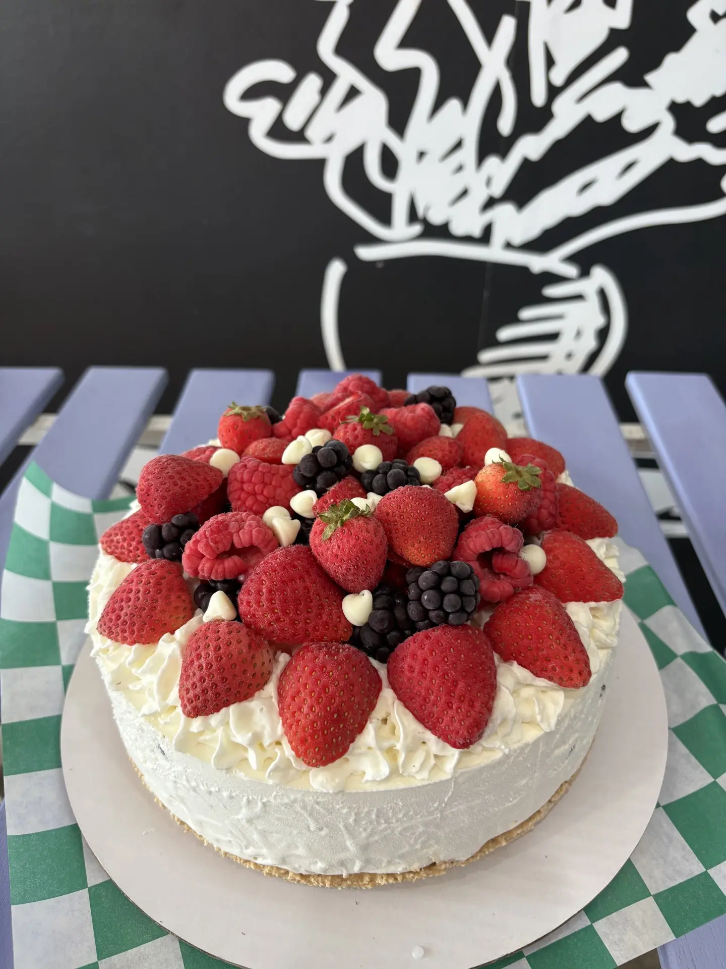 Vanilla ice cream cake topped with strawberries and raspberries