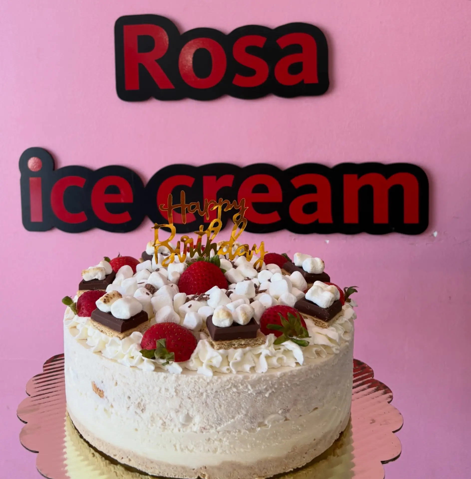 S'mores ice cream cake in front of the Rosa Ice Cream sign