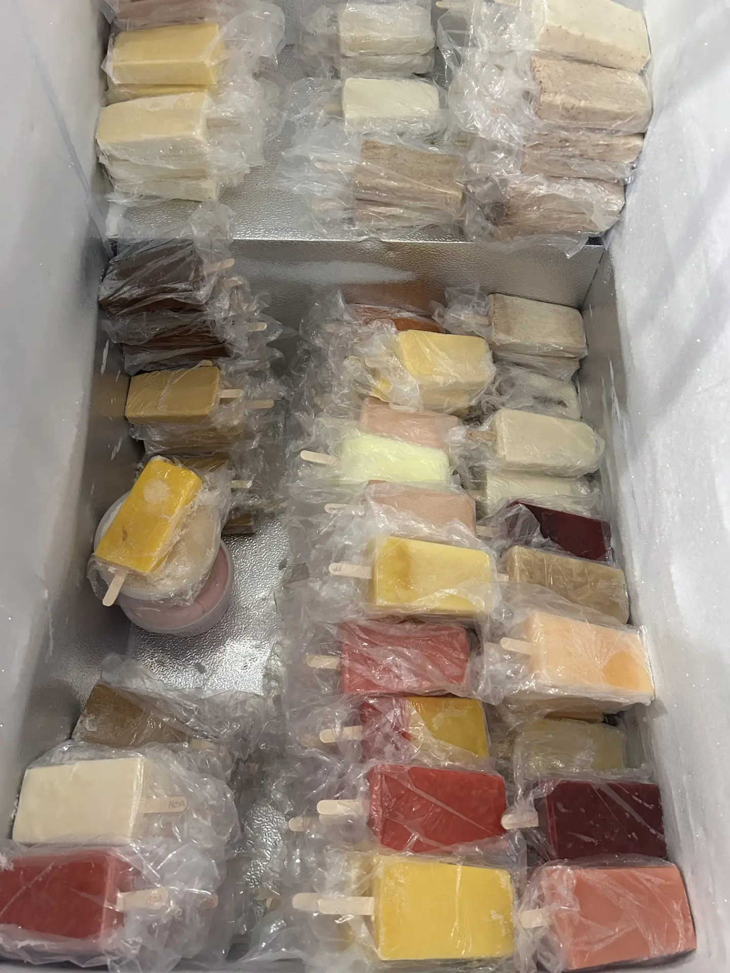 Freezer full of handmade Rosa Ice Cream popsicles in fruit and cream flavors